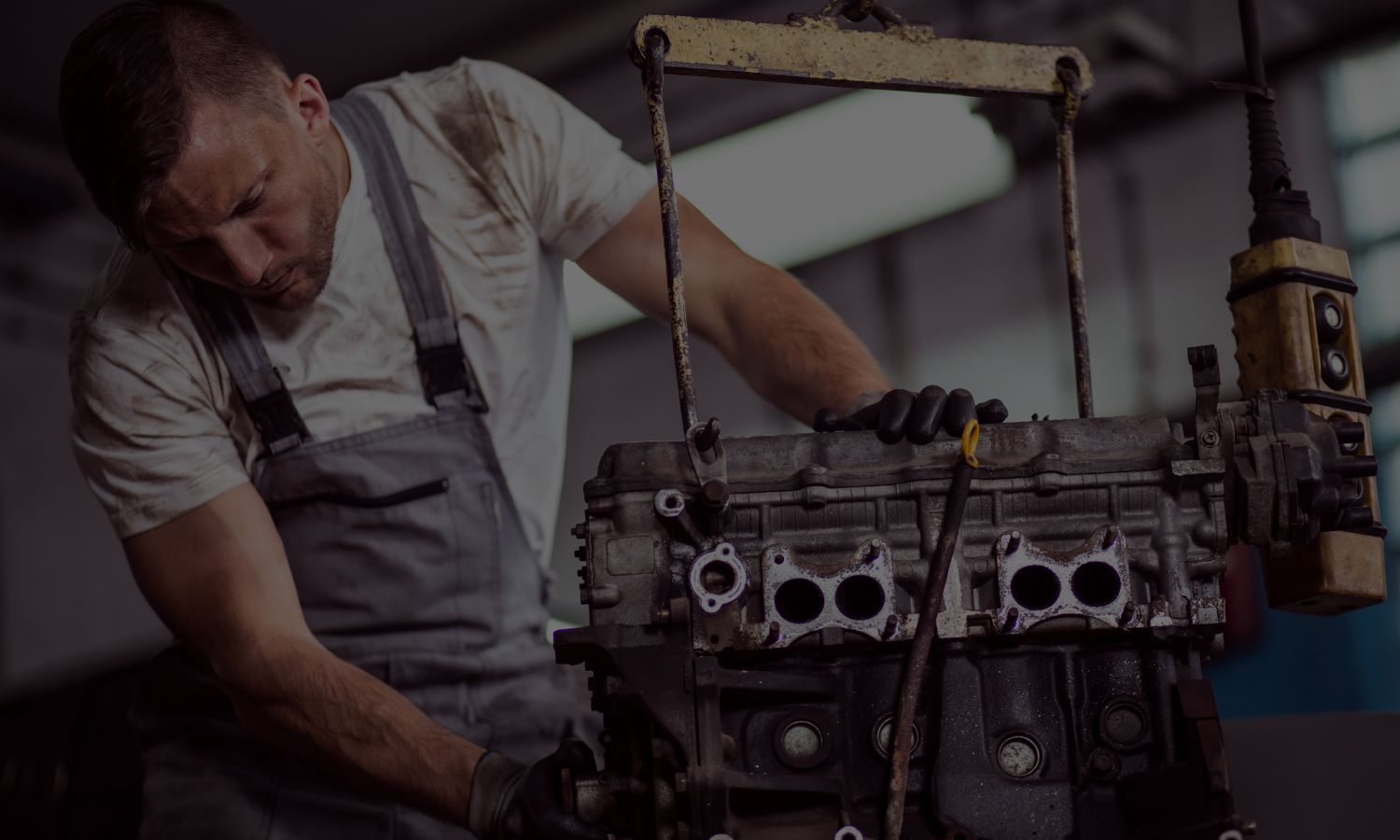 Independent workshop technician inspecting a used Renault engine before fitment